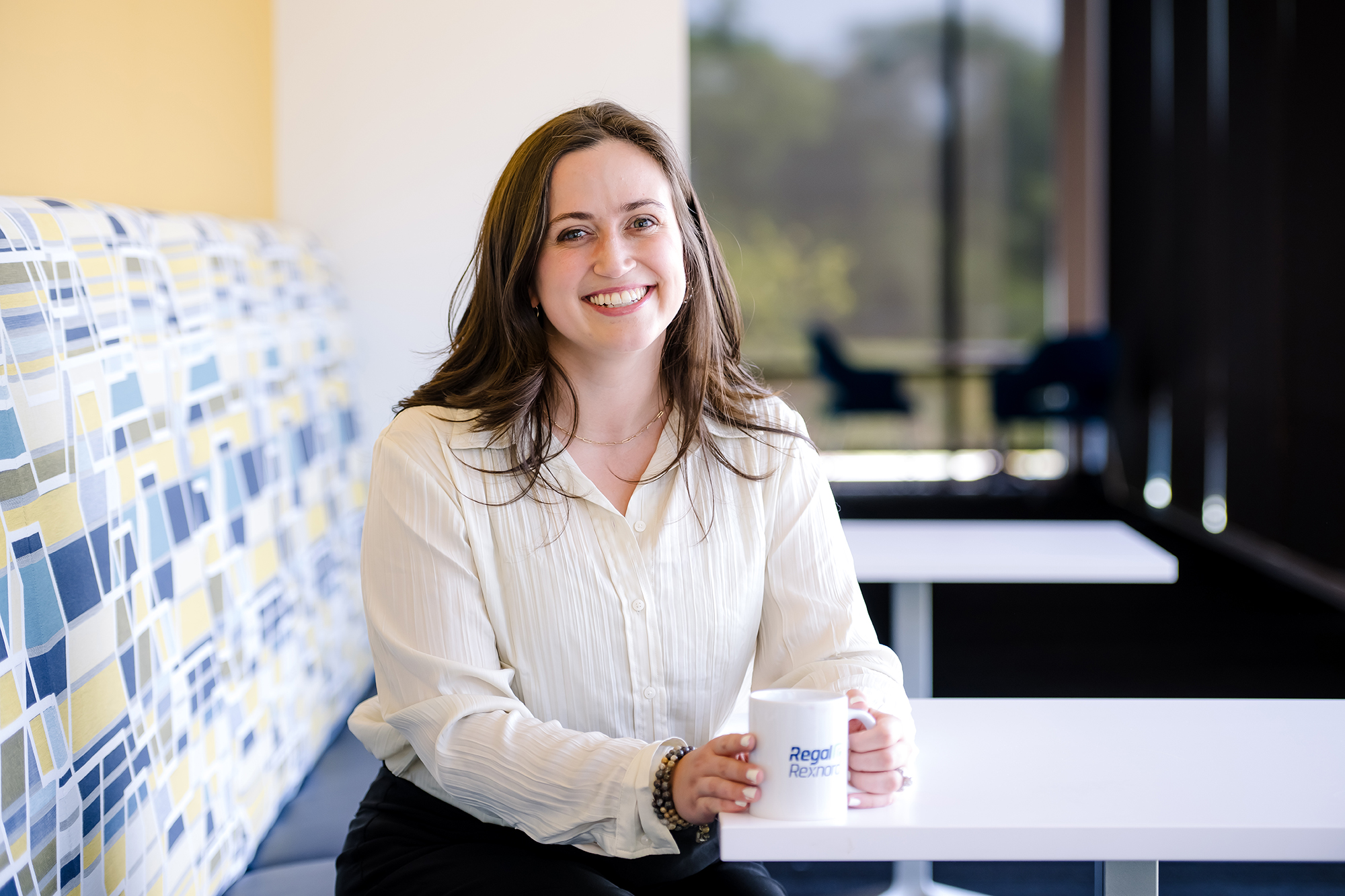 a person sitting on a bench holding a mug