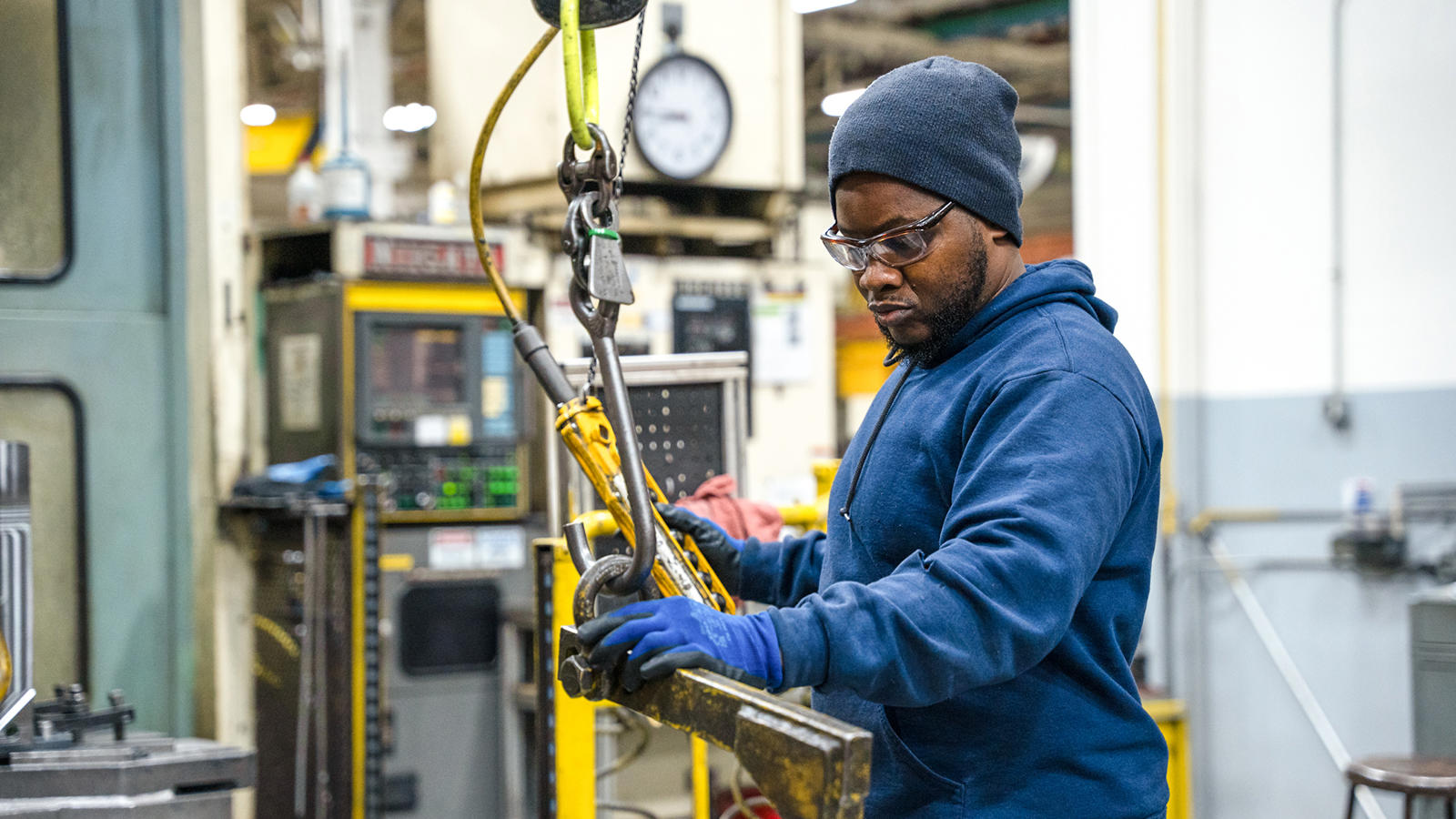 a person in a blue jacket and beanie holding a crane