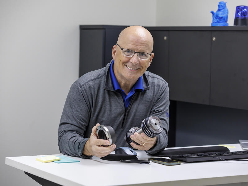 a person sitting at a desk holding a pair of objects