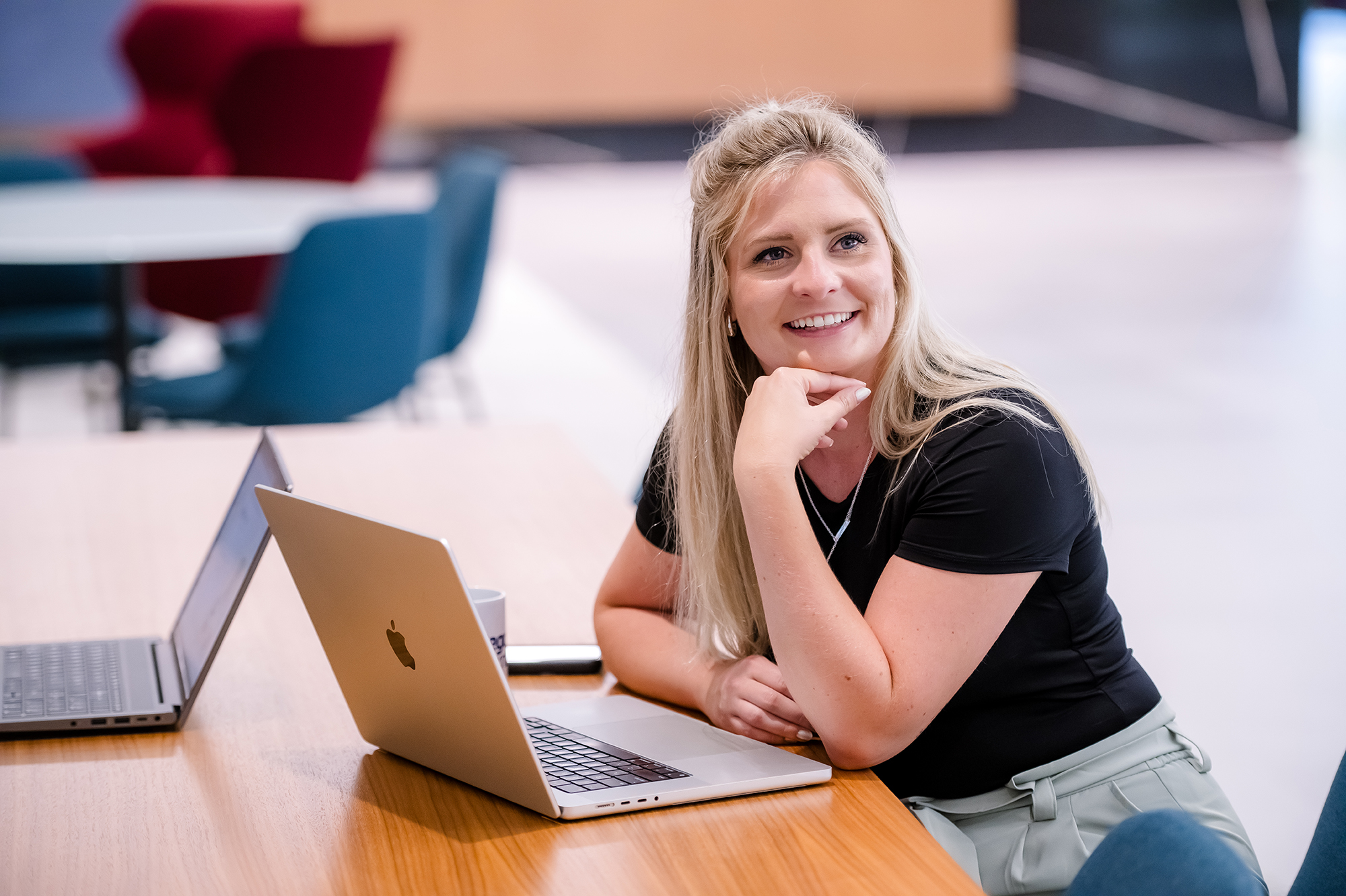 a person sitting at a table with a laptop