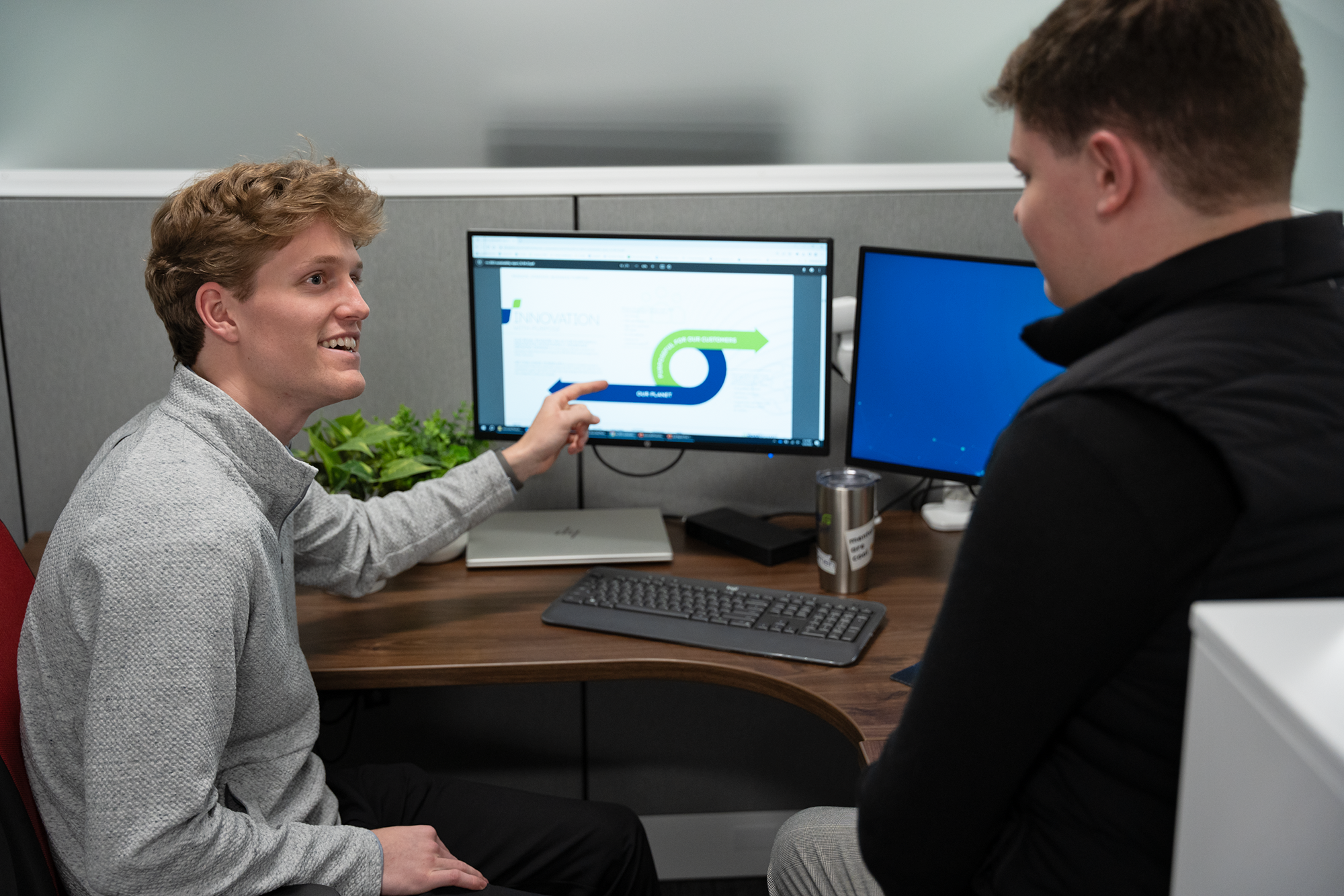 a person pointing at a computer screen