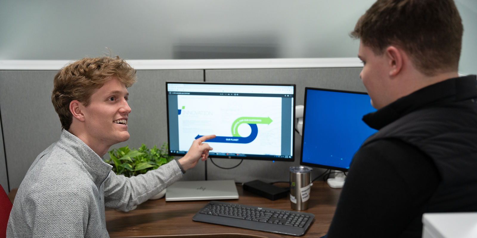 a person pointing at a computer screen