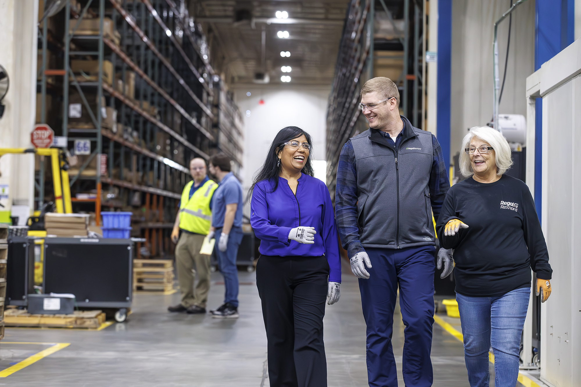 a group of people walking in a warehouse