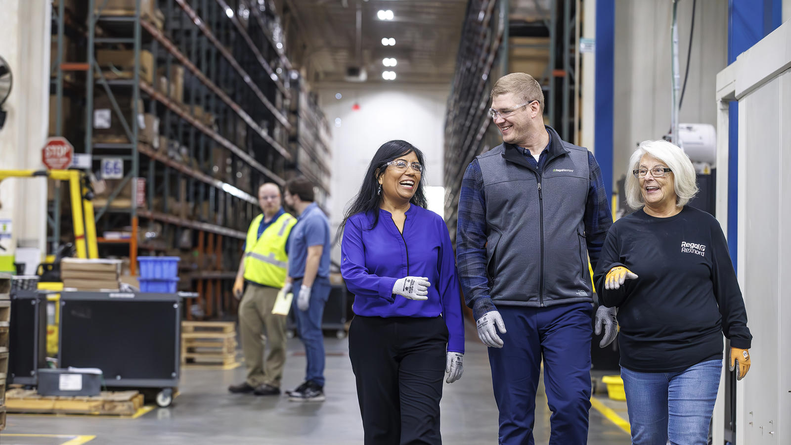 a group of people walking in a warehouse