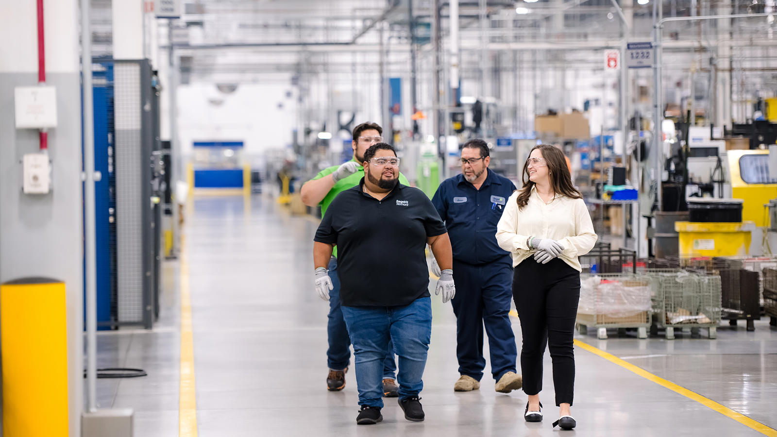 a group of people walking in a factory