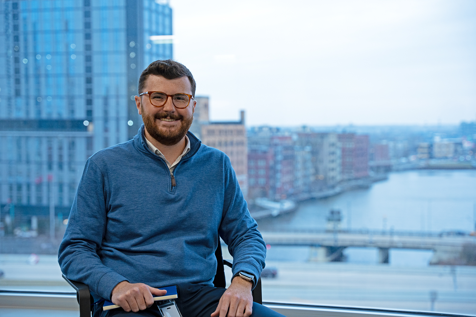 a person sitting in a chair with a city in the background