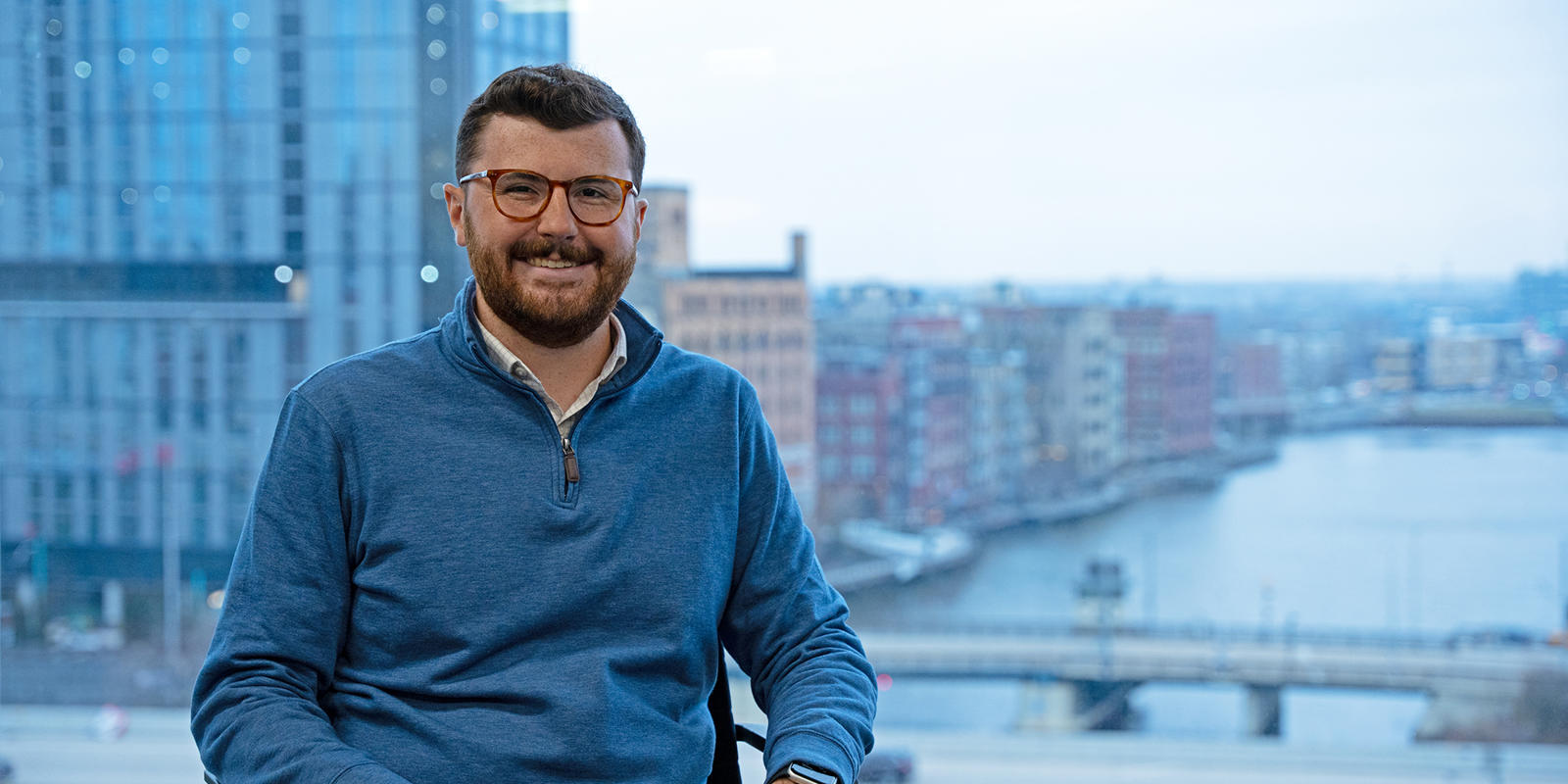 a person sitting in a chair with a city in the background