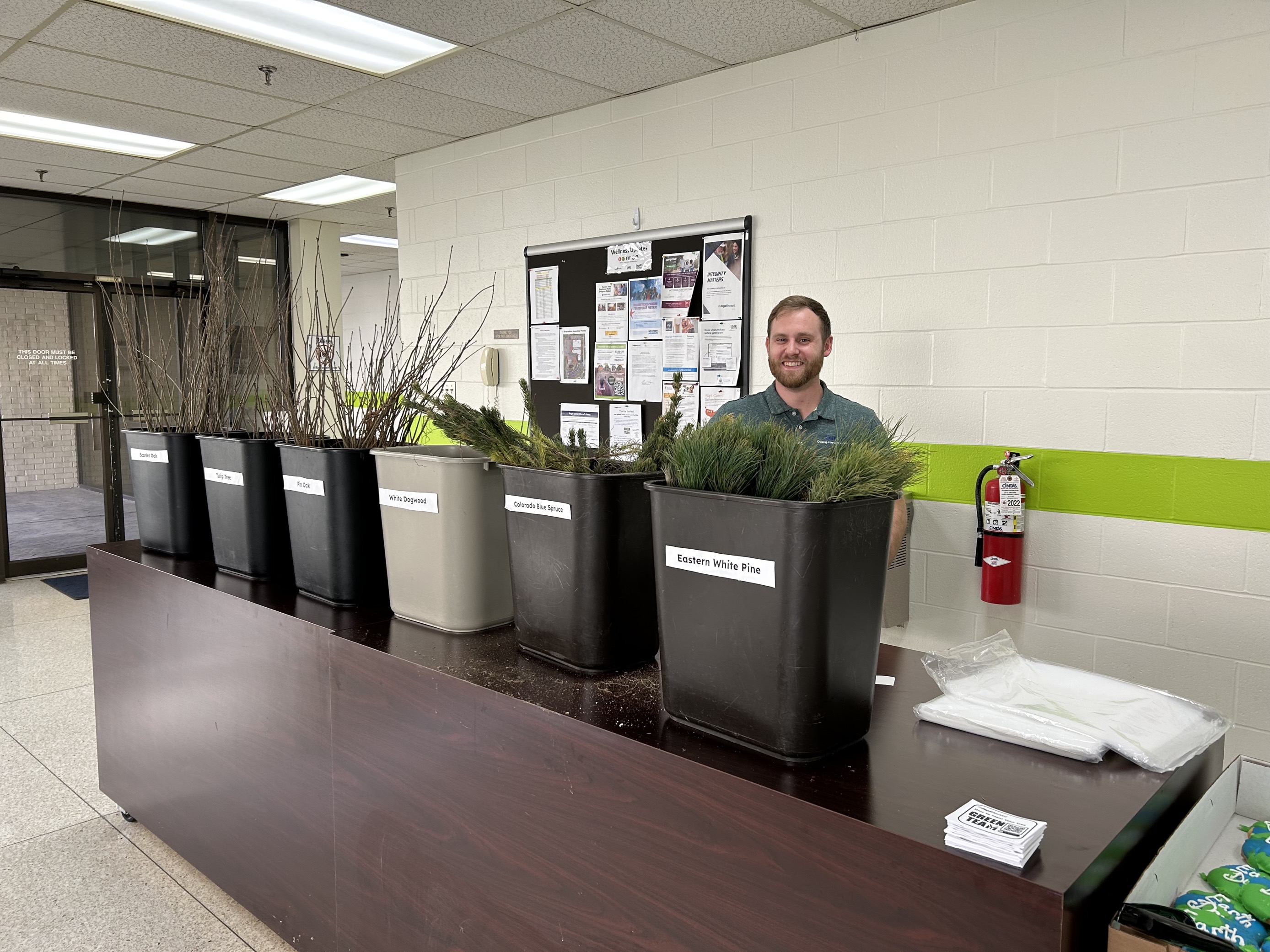 a person standing in front of several planters