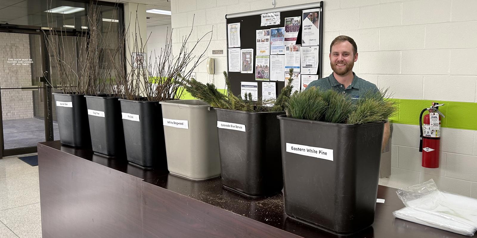 a person standing in front of several planters