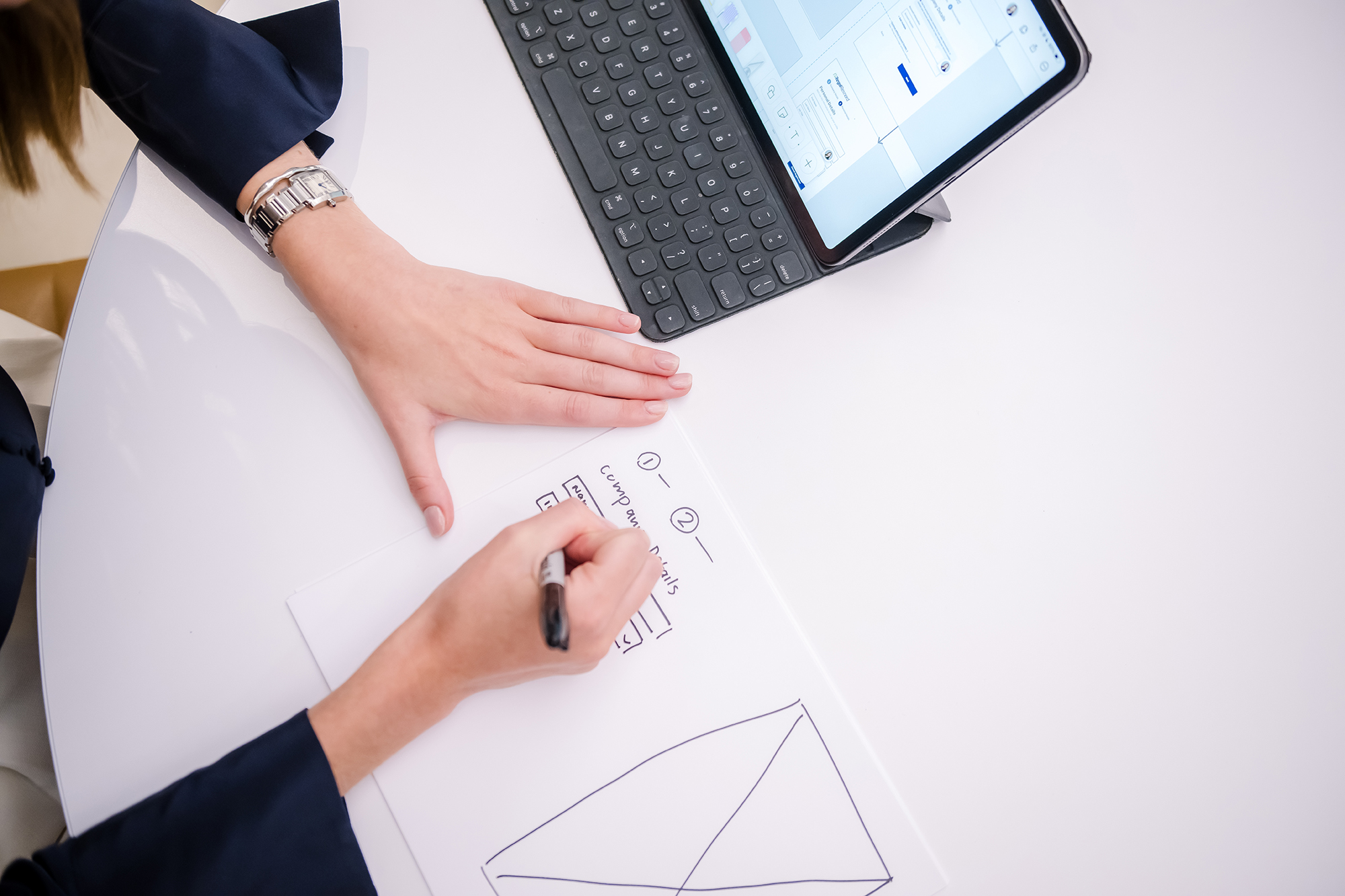 a person writing on a piece of paper