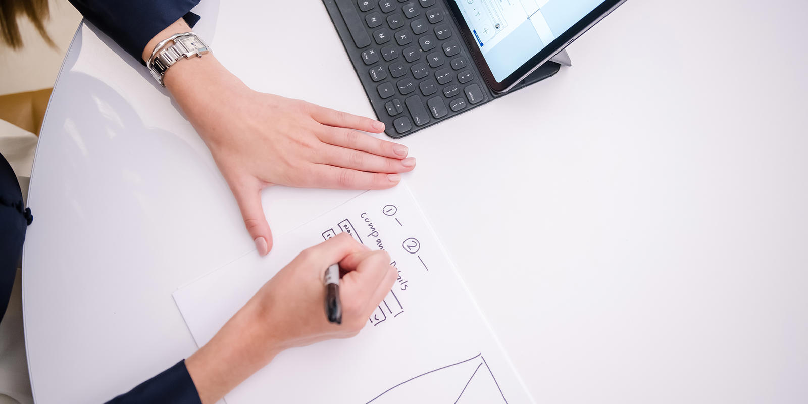 a person writing on a piece of paper