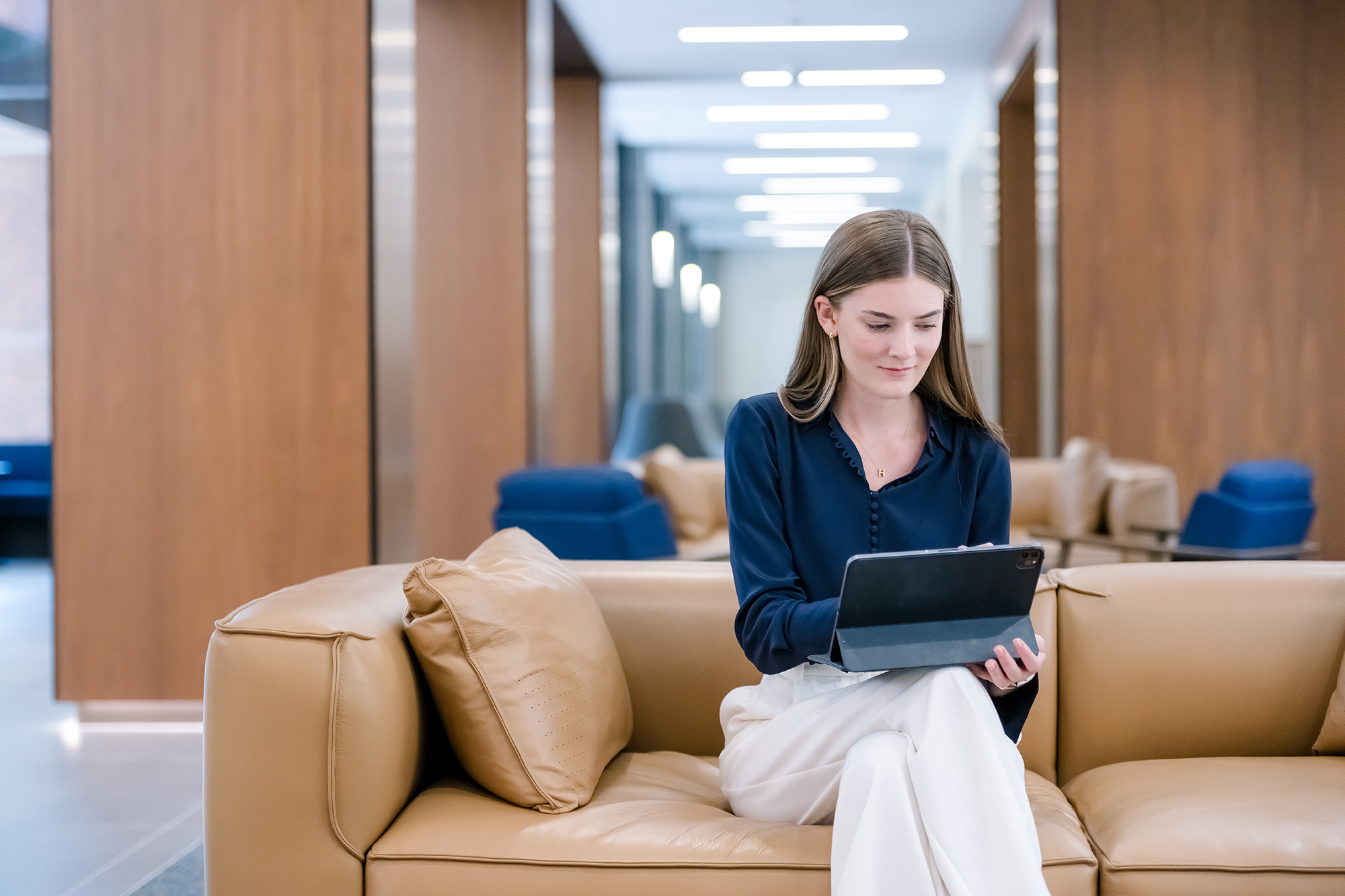 a person sitting on a couch using a laptop