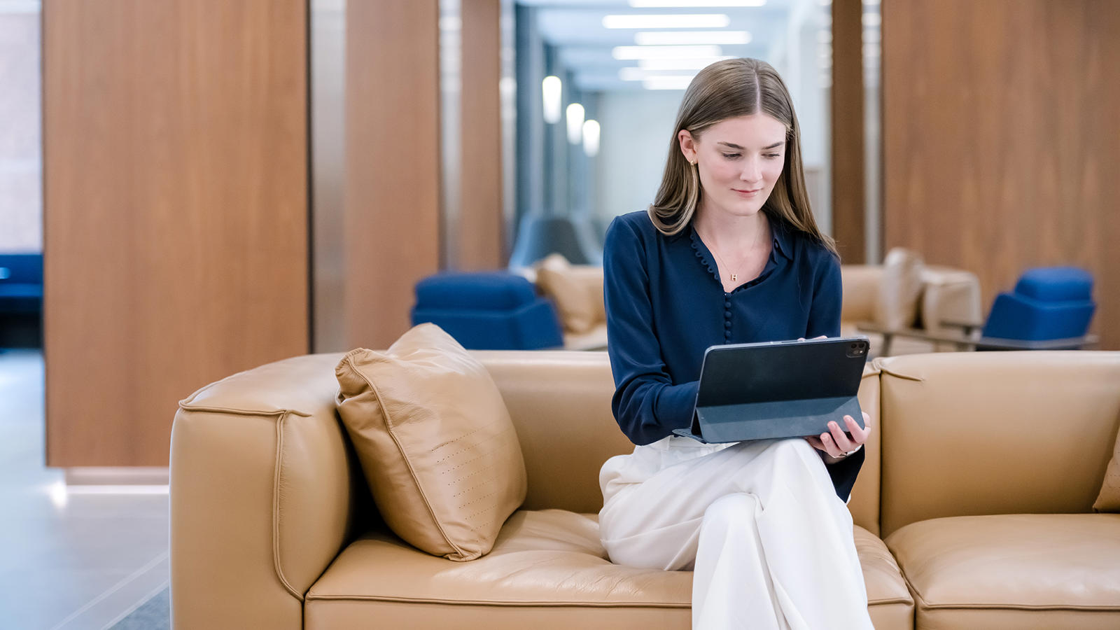 a person sitting on a couch using a laptop
