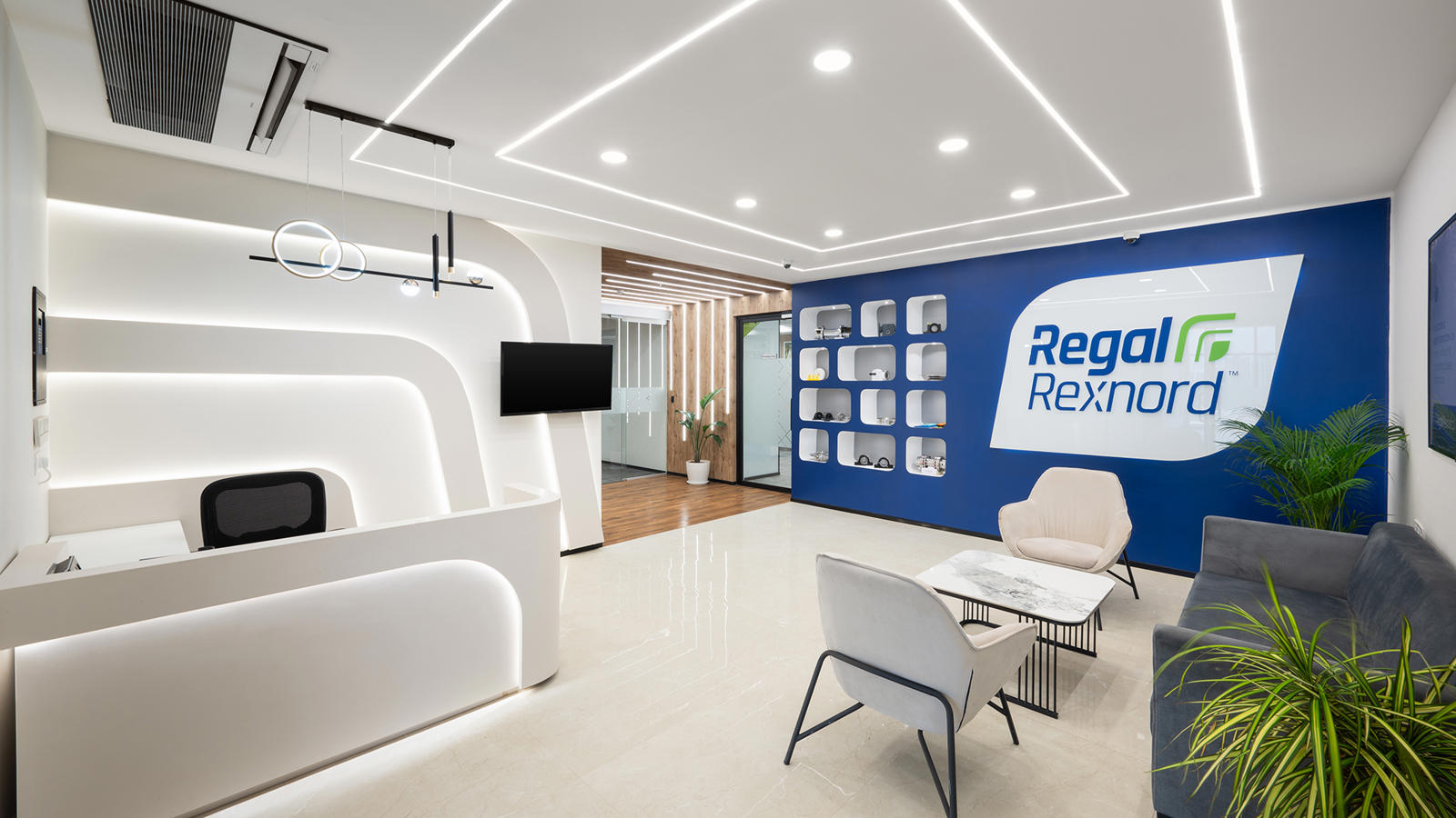 a reception area with a blue wall and white chairs