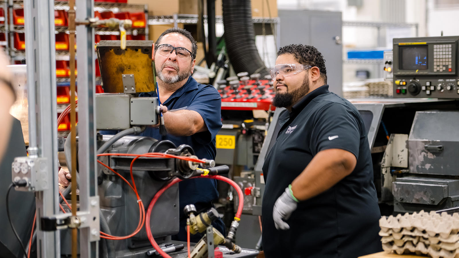 two men in a factory