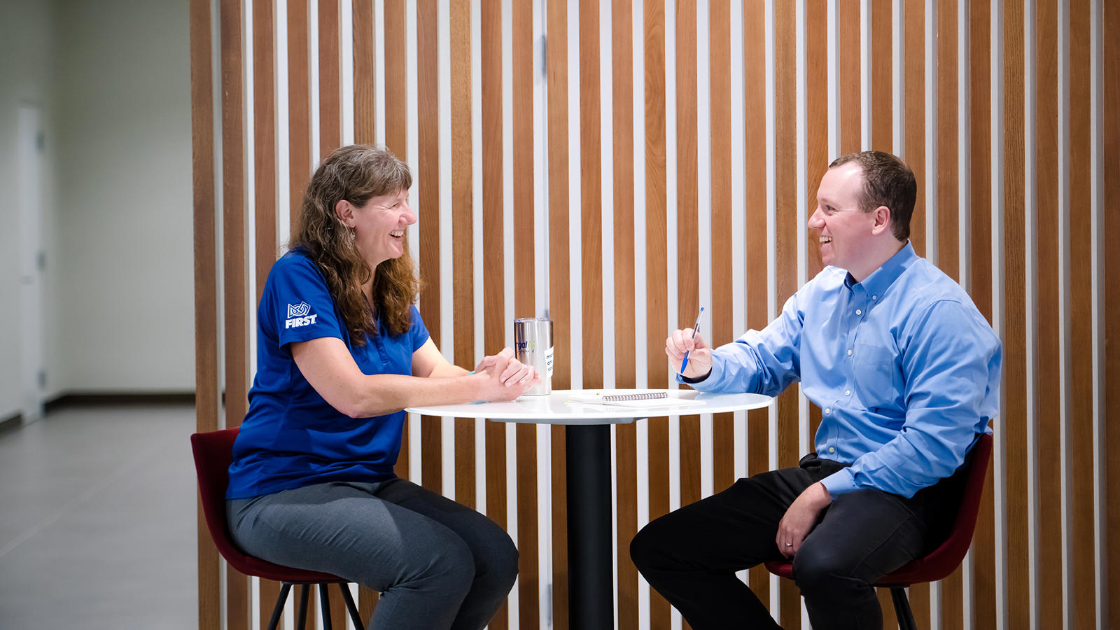 a person and person sitting at a table