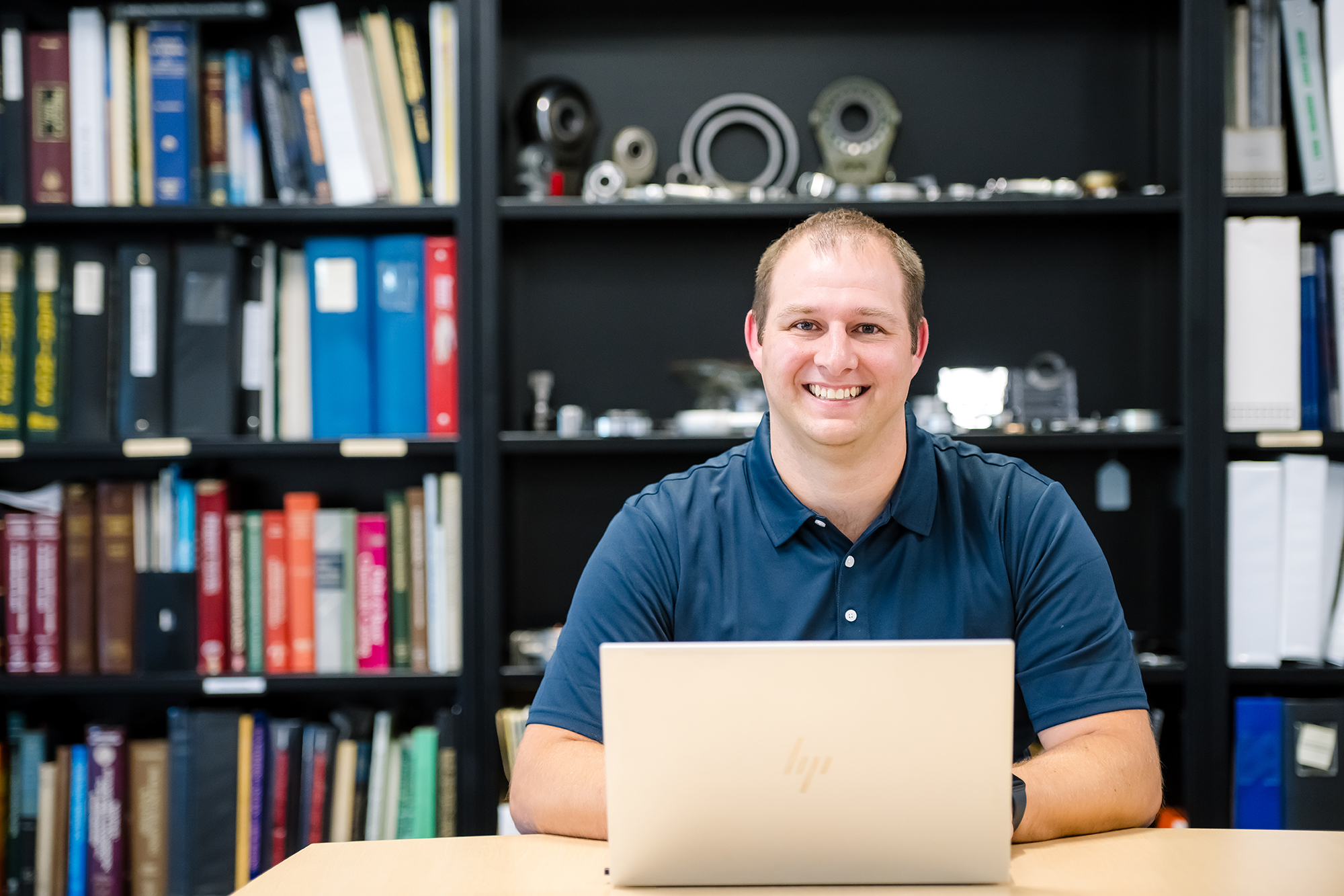 a person sitting at a desk with a laptop